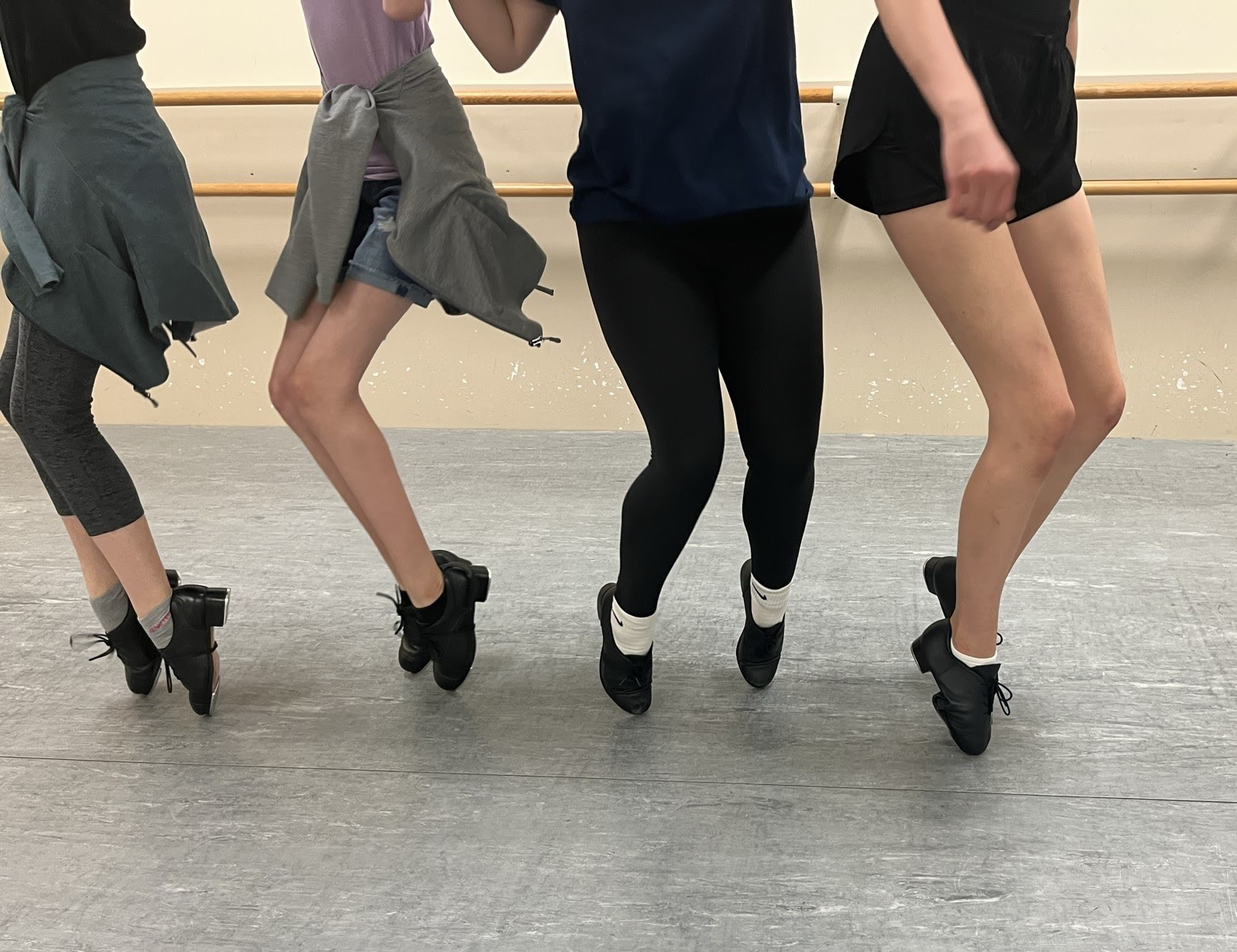 dancers legs on tip toes in tap shoes