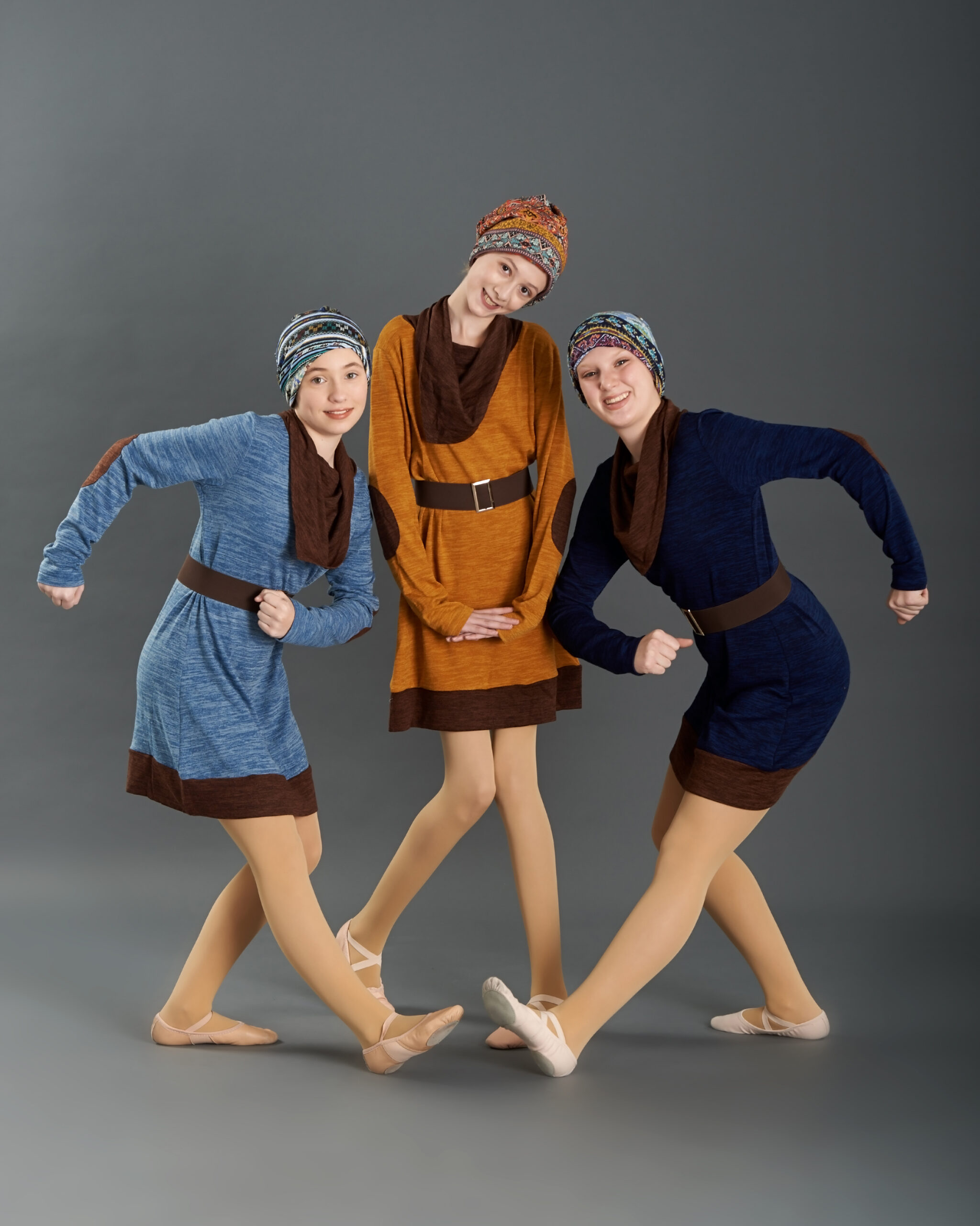 dancers posing in blue costumes with hats